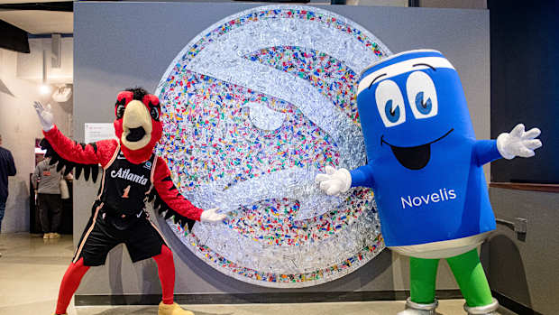 Hawks and Novelis mascots posing for a picture.